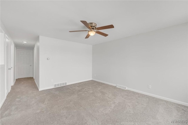 unfurnished room featuring light carpet and ceiling fan