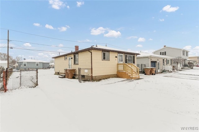 view of snow covered rear of property