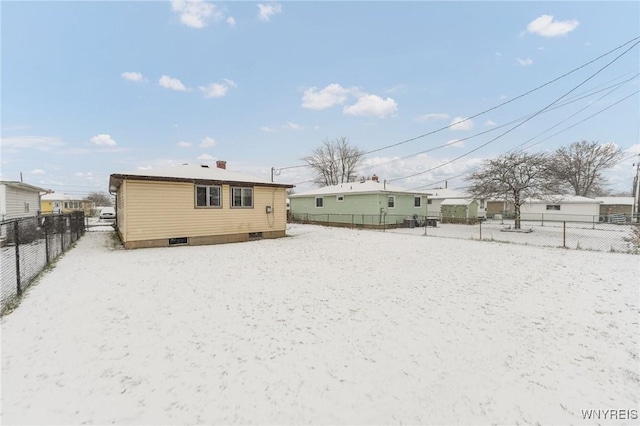 view of snow covered rear of property