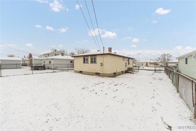 view of snow covered rear of property