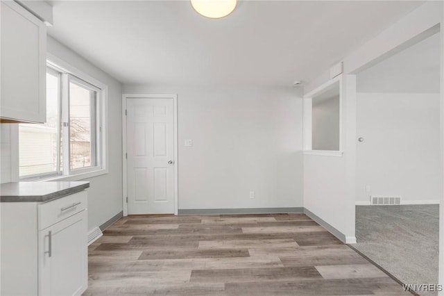 unfurnished dining area with light wood-type flooring