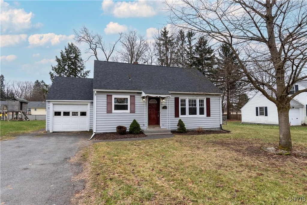 view of front of home featuring a garage and a front lawn