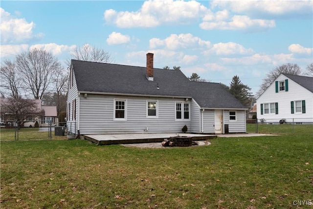 rear view of house with a lawn, a patio area, and a wooden deck