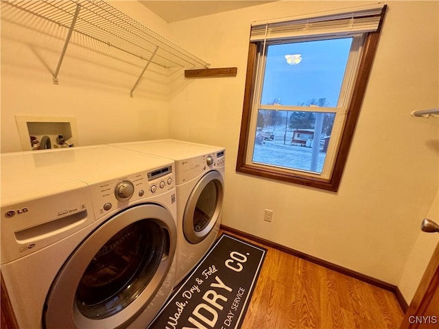 laundry room featuring light wood-type flooring and washing machine and dryer