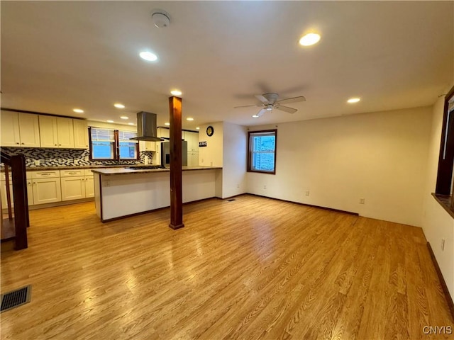 unfurnished living room with light hardwood / wood-style floors and ceiling fan