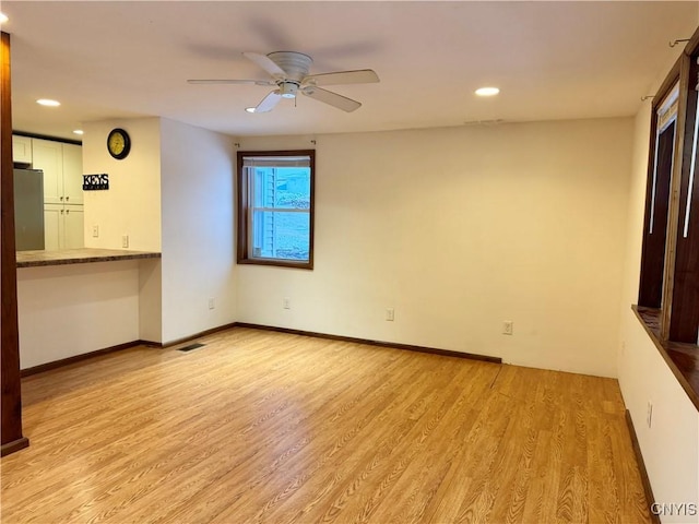 spare room with ceiling fan and light hardwood / wood-style flooring