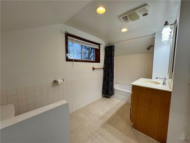 bathroom featuring tile patterned floors, vanity, tile walls, and shower / tub combo with curtain