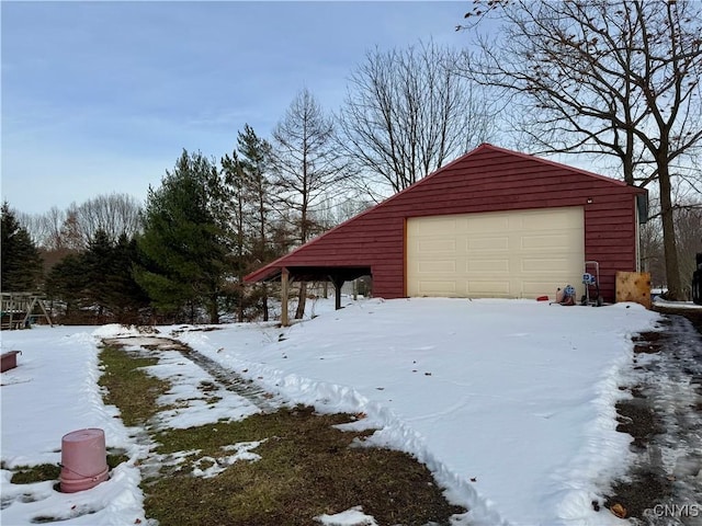 exterior space with a garage and an outbuilding