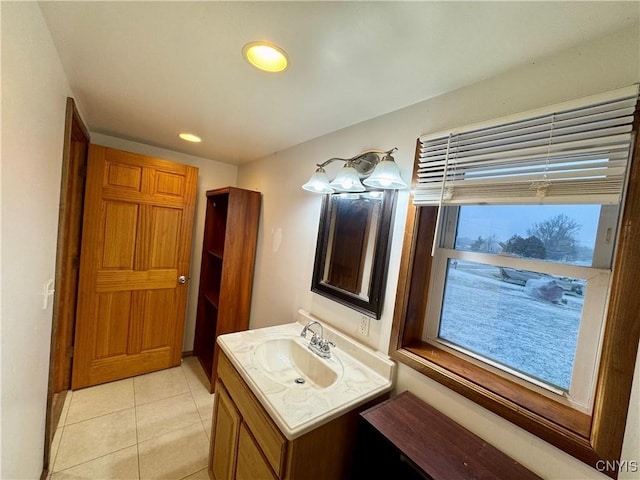 bathroom featuring tile patterned flooring, vanity, and plenty of natural light