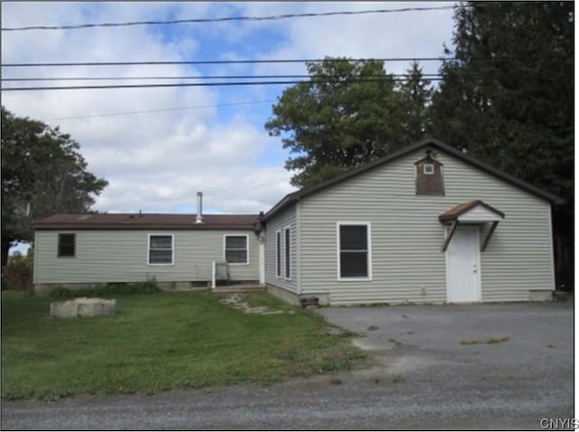 back of house with a yard