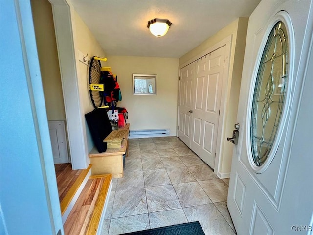 mudroom featuring light tile patterned floors and a baseboard heating unit