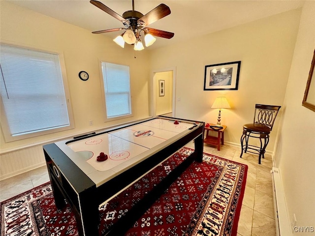 playroom with ceiling fan, light tile patterned floors, and baseboard heating