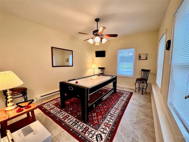 playroom featuring a baseboard radiator and ceiling fan