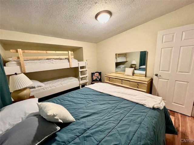 bedroom with wood-type flooring and a textured ceiling