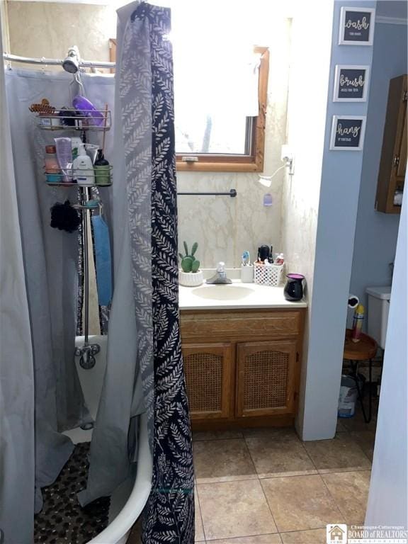 bathroom featuring tile patterned floors, curtained shower, vanity, and toilet