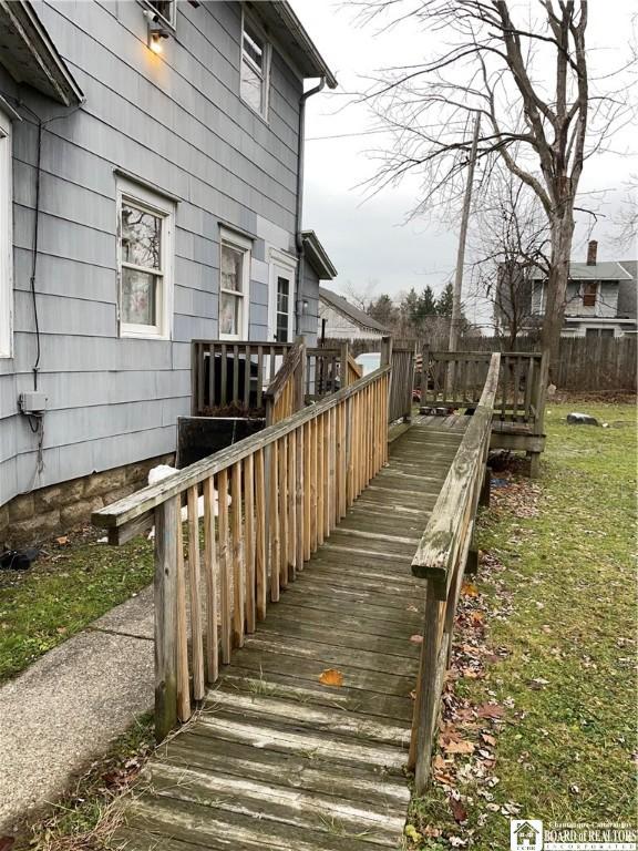 wooden deck featuring a yard