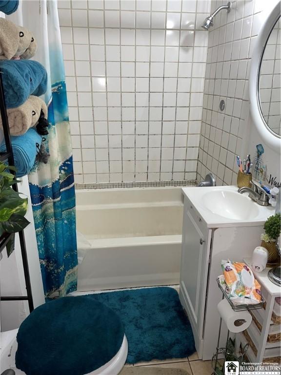 bathroom with tile patterned floors, vanity, and shower / bath combo