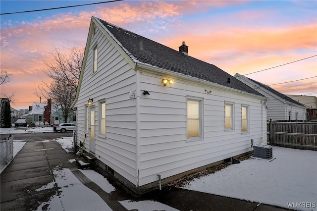 property exterior at dusk with cooling unit