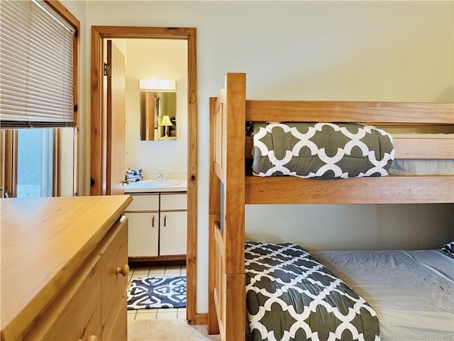 tiled bedroom featuring sink