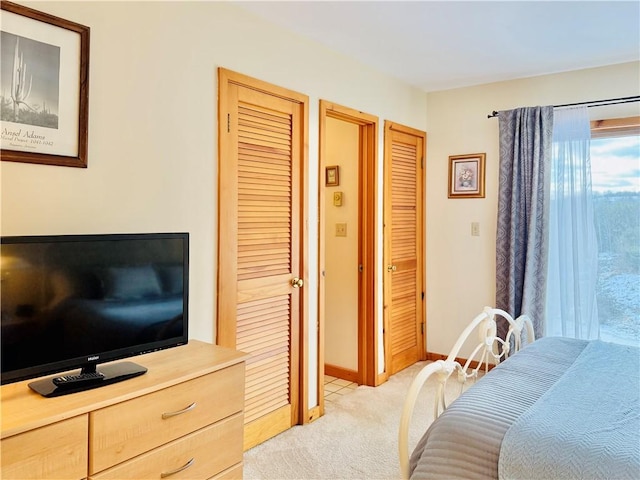 carpeted bedroom with multiple closets