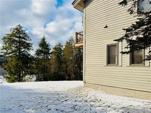 view of snowy exterior featuring a balcony