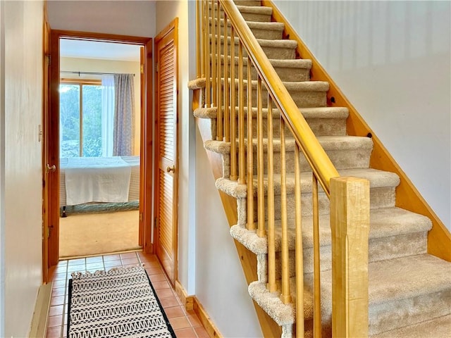 stairs featuring tile patterned flooring