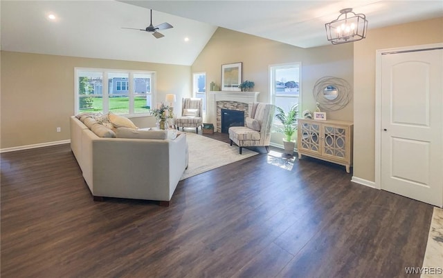 living room with a fireplace, ceiling fan with notable chandelier, dark hardwood / wood-style floors, and vaulted ceiling