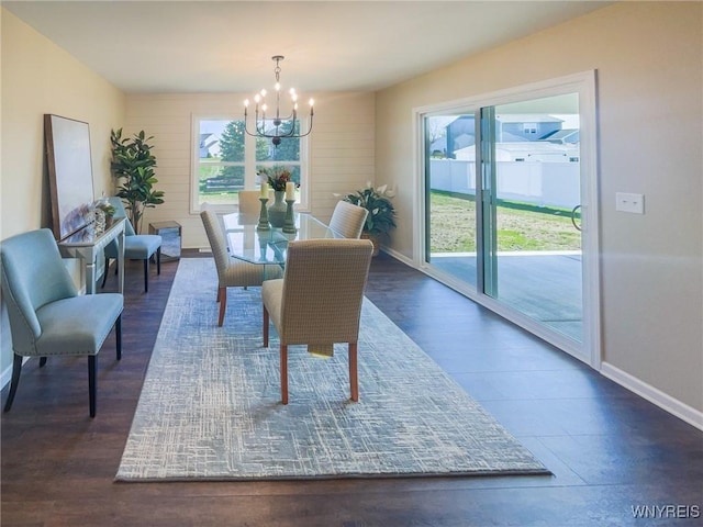 dining area featuring a notable chandelier, dark wood-type flooring, and a wealth of natural light