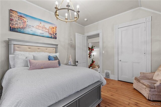 bedroom with a chandelier, crown molding, and light hardwood / wood-style floors