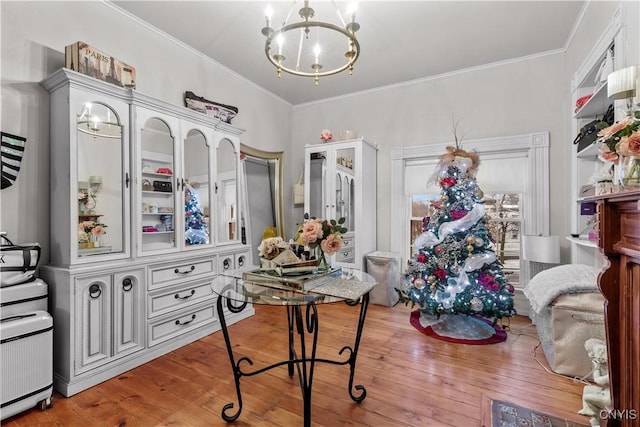 home office with wood-type flooring, crown molding, and an inviting chandelier