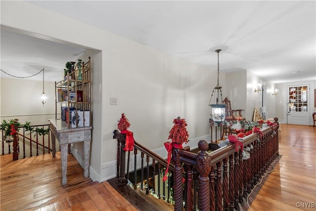 corridor with hardwood / wood-style flooring