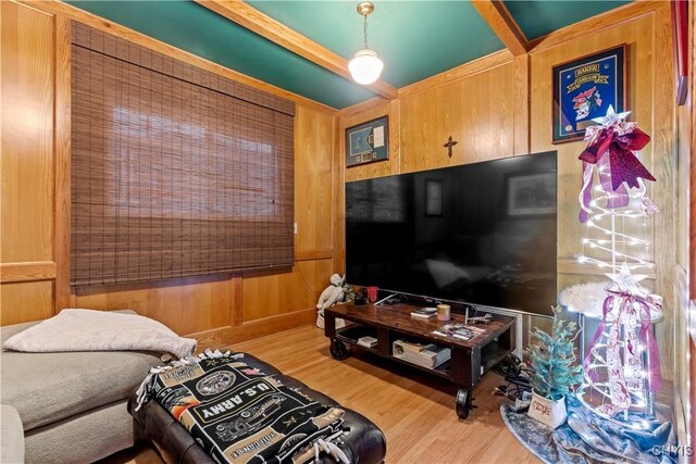 living room featuring hardwood / wood-style flooring and wood walls