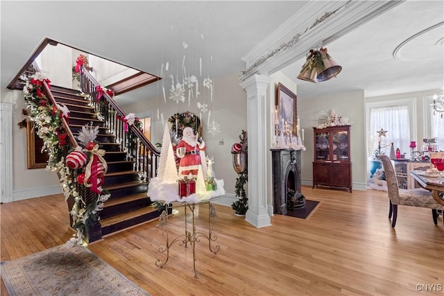 interior space featuring hardwood / wood-style floors and decorative columns