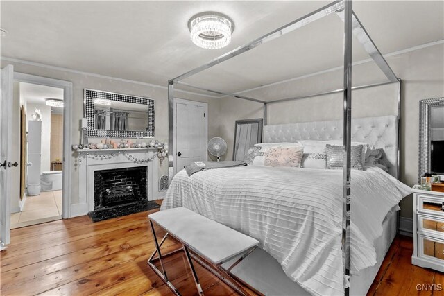 bedroom with crown molding and hardwood / wood-style floors