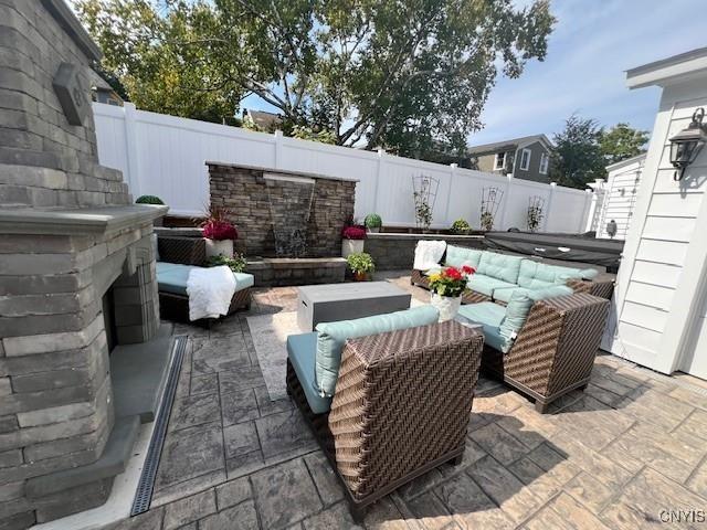 view of patio featuring an outdoor living space with a fireplace