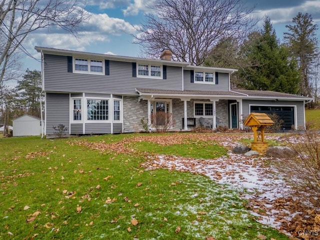 view of front of property with a garage and a front lawn