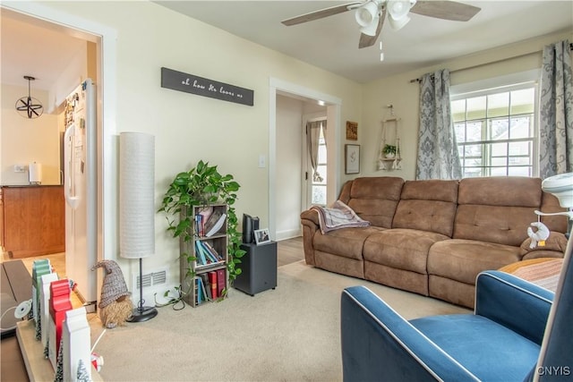 living room featuring carpet floors and ceiling fan