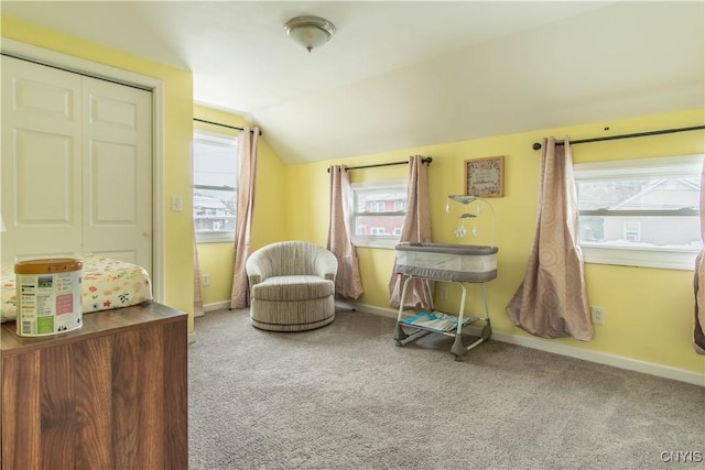 sitting room featuring carpet floors and vaulted ceiling