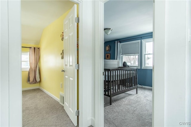 hallway with light colored carpet