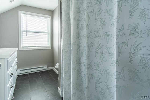 bathroom featuring lofted ceiling, tile patterned flooring, vanity, a baseboard heating unit, and toilet