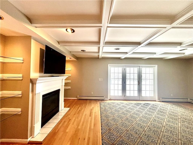 unfurnished living room with coffered ceiling, a fireplace with flush hearth, french doors, light wood-type flooring, and a baseboard heating unit