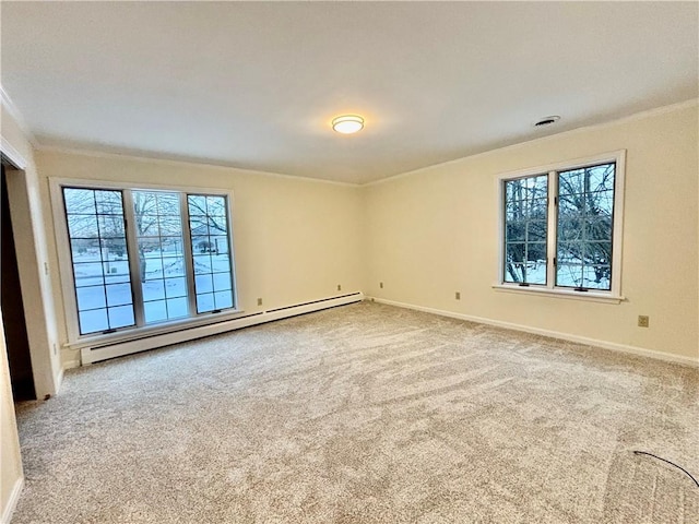 empty room with a baseboard heating unit, a healthy amount of sunlight, carpet flooring, and crown molding