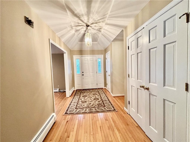 entryway with light wood-type flooring, a baseboard heating unit, and baseboards