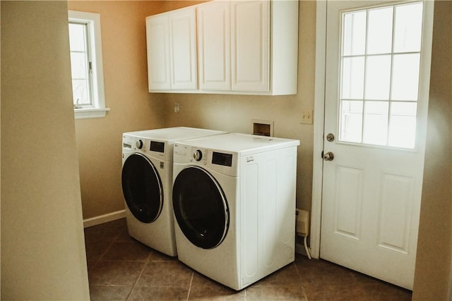 laundry area featuring separate washer and dryer, tile patterned flooring, cabinet space, and baseboards