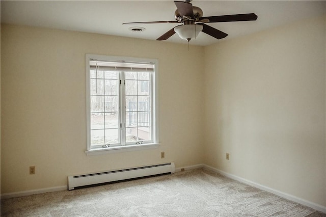 empty room featuring a baseboard heating unit, carpet floors, baseboards, and a healthy amount of sunlight