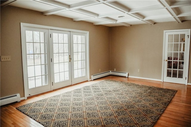 interior space featuring plenty of natural light, coffered ceiling, wood finished floors, french doors, and a baseboard heating unit