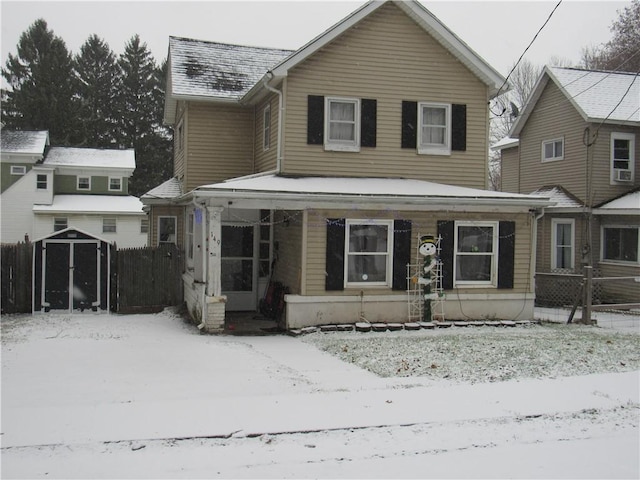 view of front of house featuring a storage unit