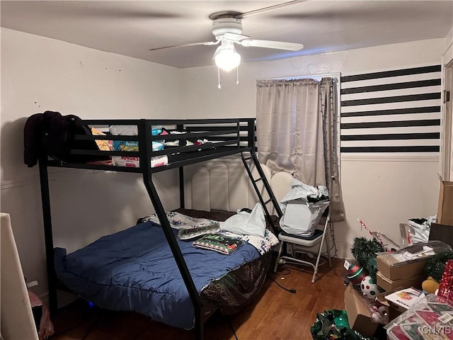 bedroom featuring hardwood / wood-style floors and ceiling fan