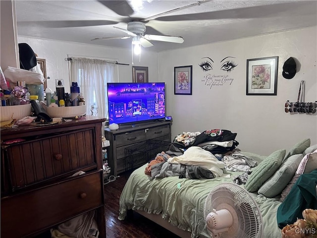 bedroom with ceiling fan and dark hardwood / wood-style flooring