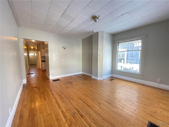 spare room with light hardwood / wood-style floors